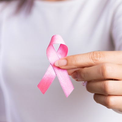 Woman hand holding pink ribbon