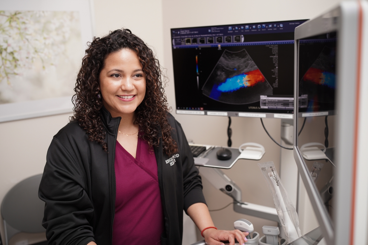 Female radiography technician at a computer viewing patient ultrasound