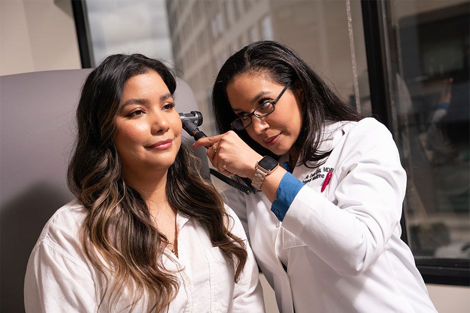 Dr. Flavia De La Cruz examines a patient