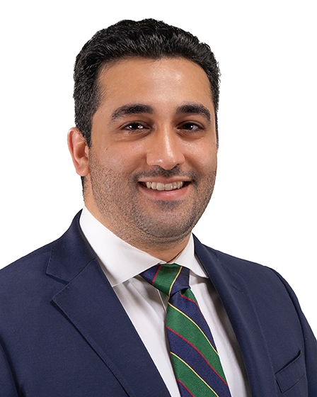 male with blue suit and green tie